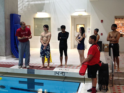 Larry Anderson talking to students at pool
